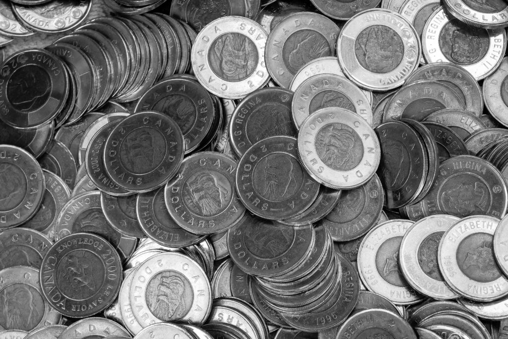 pexels-photo-24245347-24245347 Close-up of Canadian coins in a monochrome color scheme, depicting wealth and currency.